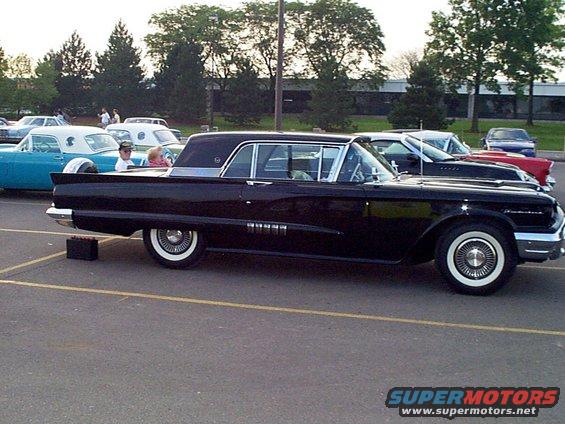 Black 1960 Ford Thunderbird coupe parked in a lot with other cars
