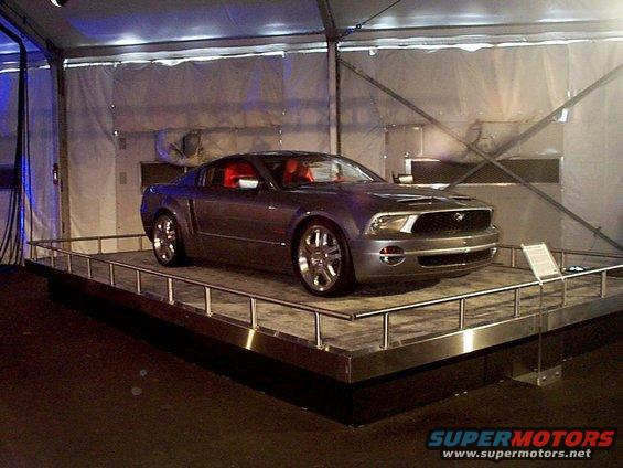 Gray coupe with red interior, 2005 model year, on display platform
