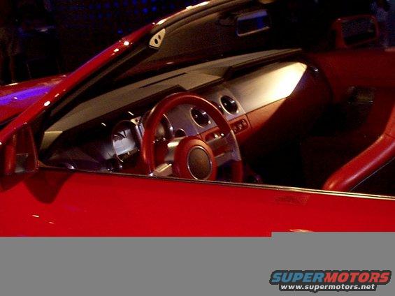 Red convertible interior with a prominent steering wheel and dashboard