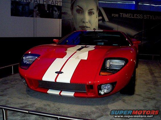 Red Ford GT with white racing stripes, front view
