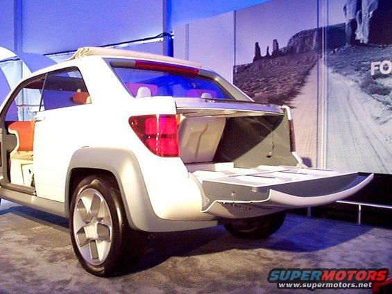 White concept SUV with open tailgate and doors, showing orange interior, rear view