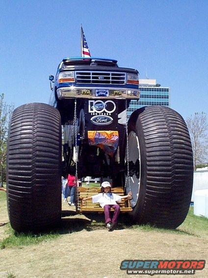 Monster truck front view with 100 Years Ford badge and child on swing