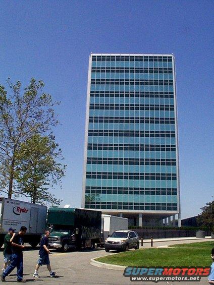 Office building with Ryder truck, box truck, and SUV parked nearby