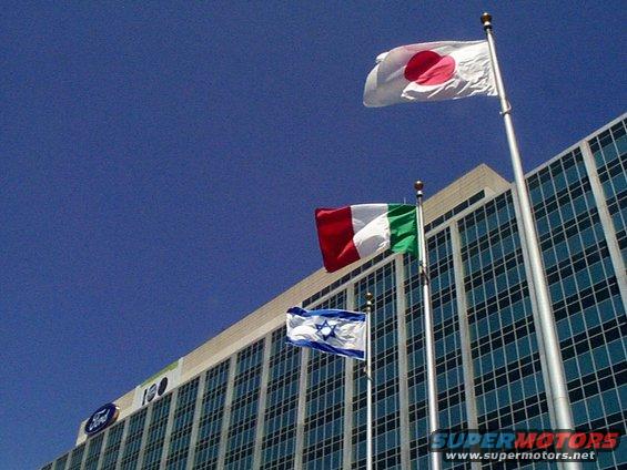 Ford building with Japanese, Italian, and Israeli flags flying