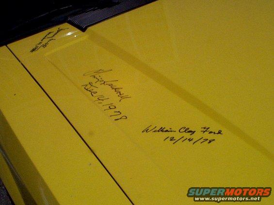 Yellow car hood with signatures and dates, including William Clay Ford 12/14/78