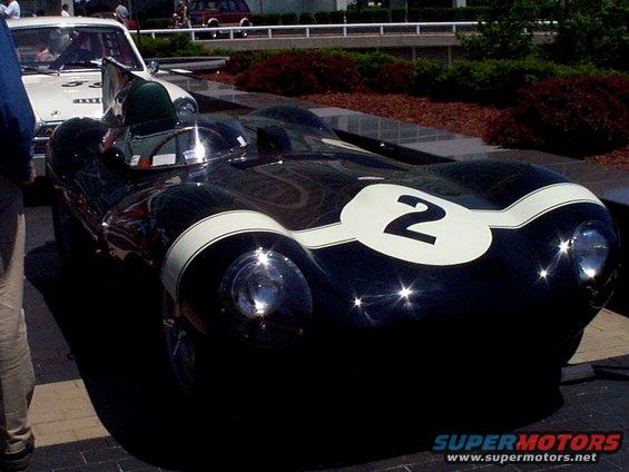 Dark racing car with white stripes and number 2