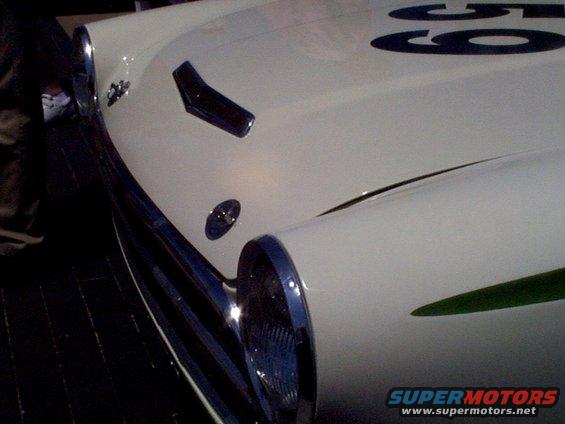 White race car front with green stripe and number 59