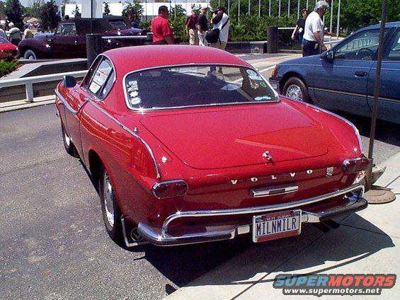 Red Volvo P1800 coupe, rear view, chrome bumper, custom license plate MILNMILR