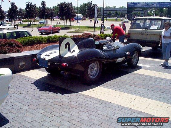 Black race car with white numbers 2 and 4, viewed from the rear