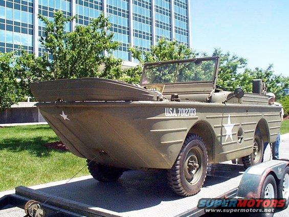 Olive drab amphibious vehicle with USA 7012703 marking on trailer