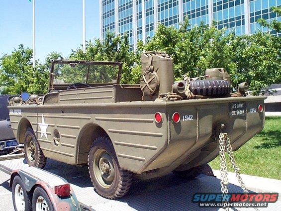 Olive drab military amphibious vehicle with a white star emblem and '1942' visible on the rear
