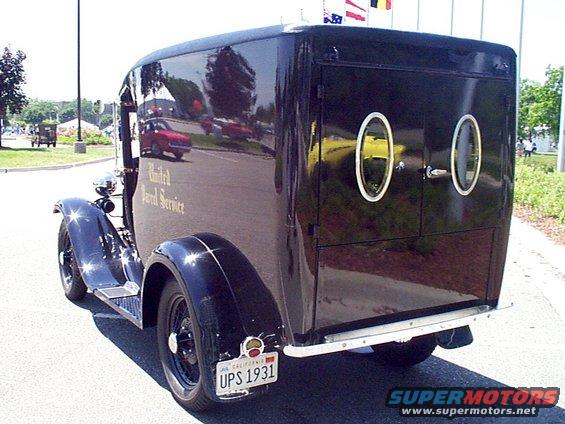 Black United Parcel Service truck with oval windows and California license plate UPS 1931