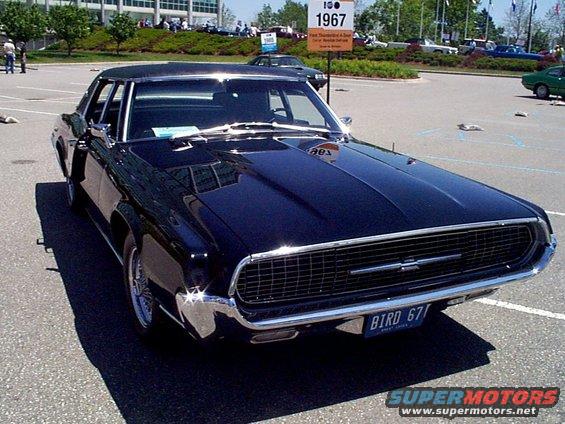 Black 1967 Ford Thunderbird with a chrome grille and a license plate that says BIRD 67