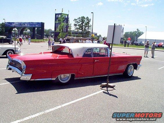 Red 1958 Lincoln Continental Mark III convertible with a white top
