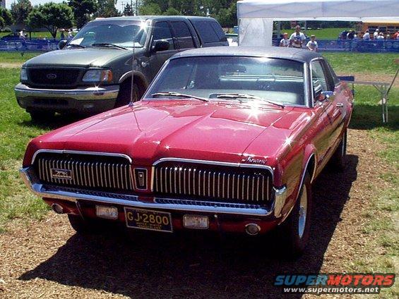 1969 Mercury Cougar XR7 front view, parked next to a dark SUV