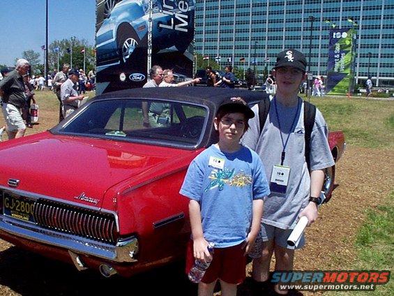 Red 1969 Mercury Cougar with license plate GJ-2800, two boys standing next to it