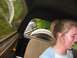 1988 Ford Bronco - View from inside a vehicle, looking out at a spare tire and the front of another vehicle.