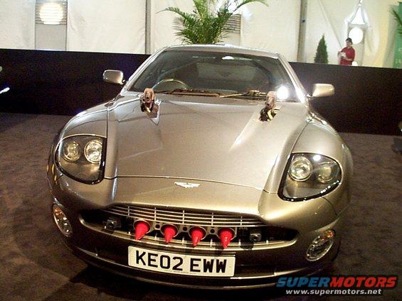 Silver Aston Martin Vanquish with red cones in grille and license plate KE02 EWW