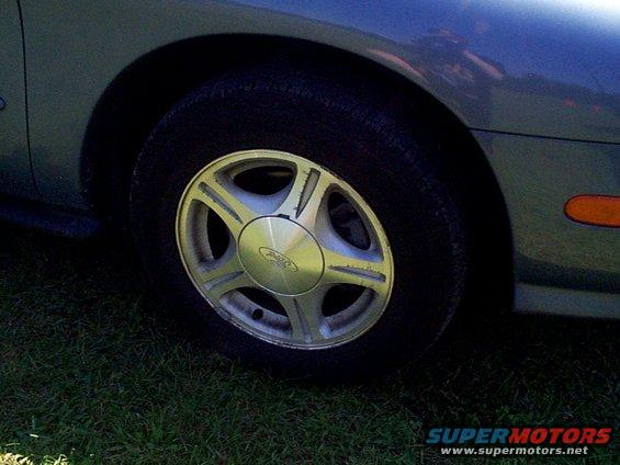 Close-up of a 1999 Ford Taurus SE alloy wheel with a Ford logo center cap