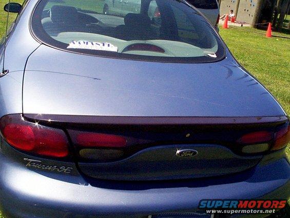 Rear of blue 1999 Ford Taurus SE with spoiler and tinted taillights