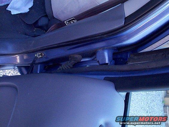 Blue 1999 Ford Taurus interior door frame with visible wiring harness and Supermotors.net logo