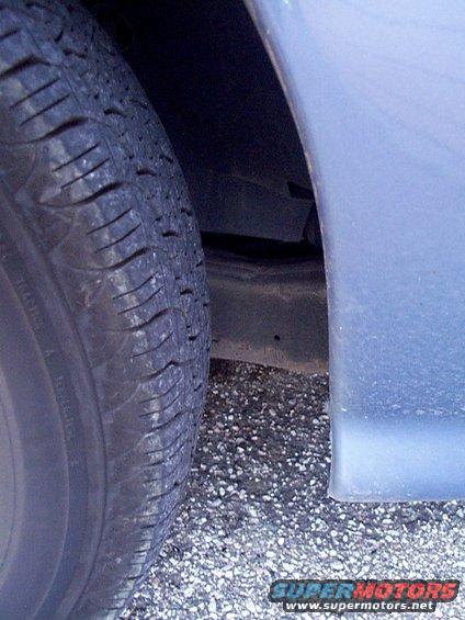 Close-up of a car's front tire and fender area