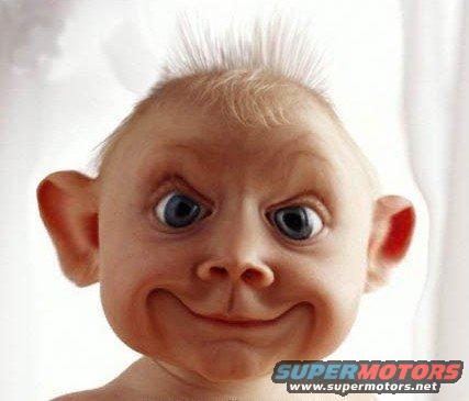 Baby with wide eyes and a mischievous grin, text 'SUPERMOTORS' visible