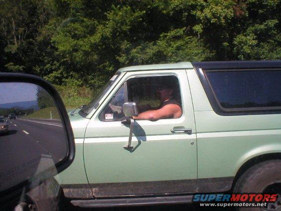 Light green SUV with black trim and tinted rear windows, seen from the side