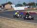 1990 Ford Bronco - Go-karts compete on a sunny day at a race track.