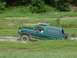 1995 Ford Bronco - A green 1995 Ford Bronco navigates a muddy off-road course.