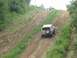 1995 Ford Bronco - Ford Bronco ascends a challenging dirt incline, with another vehicle visible at the summit.