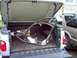 2003 Ford F-150 - A custom motorcycle frame is being transported in the bed of a pickup truck.