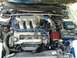 1993 Ford Probe - The engine bay of a 1993 Ford Probe, its V6 engine and an aftermarket air intake system.