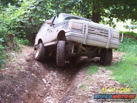 Ford Bronco going off-road on a dirt path