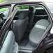1999 Ford Crown Victoria - View of the rear interior of a sedan, showing the back seats and door panel.