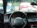 1999 Ford Crown Victoria - The interior of a sedan is shown, with two other vehicles parked outside.