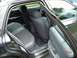 1999 Ford Crown Victoria - The interior of a dark sedan is visible with both rear doors and the driver's side front door open, revealing the back seats and dashboard.