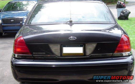 Rear view of a dark sedan parked next to a blue sedan. License plate is from Pennsylvania