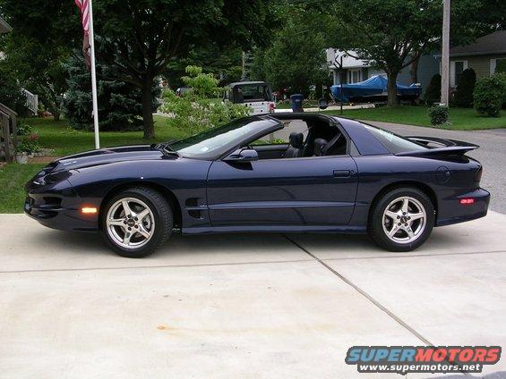 Dark blue Pontiac Firebird parked on a driveway. It has a removable t-top roof