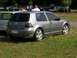 1990 Jeep YJ - Silver Volkswagen Golf GTI with tinted windows and aftermarket wheels.