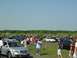 1990 Jeep YJ - A gathering of vehicles in an outdoor lot under a clear blue sky.