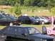 1990 Jeep YJ - Several cars are parked on a grassy field during an outdoor event.