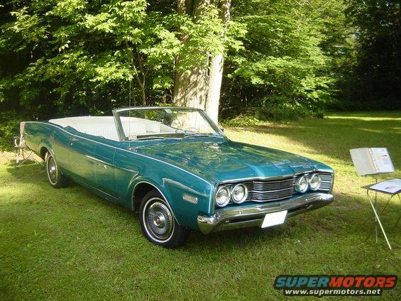 1968 Mercury Comet convertible parked on grass with trees in background