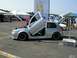 1990 Jeep YJ - A silver hatchback is displayed with its hood and doors open, custom modifications at an outdoor event.
