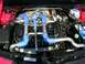 1990 Jeep YJ - Customized engine bay features prominent blue silicone hoses and polished metal piping for the turbo system.