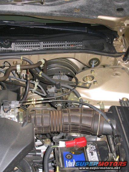 2000 Honda Accord engine bay with air intake, battery, and brake booster visible