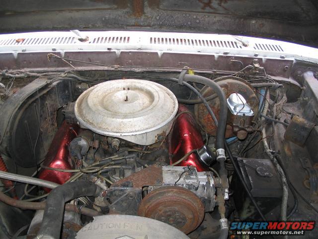 Engine bay of a 1979 Ford F-250 with a V8 engine and air cleaner