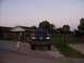 1989 Ford Bronco - A dark blue Ford F-Series truck is parked in a driveway with two children in the foreground.