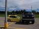 1989 Ford Bronco - A black 1989 Ford F-Series truck is parked in front of a yellow Honda Civic.
