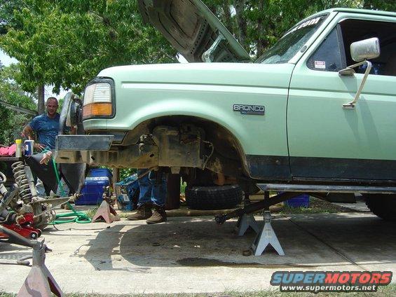 1993 Ford Bronco with hood up, on jack stands, front end disassembled